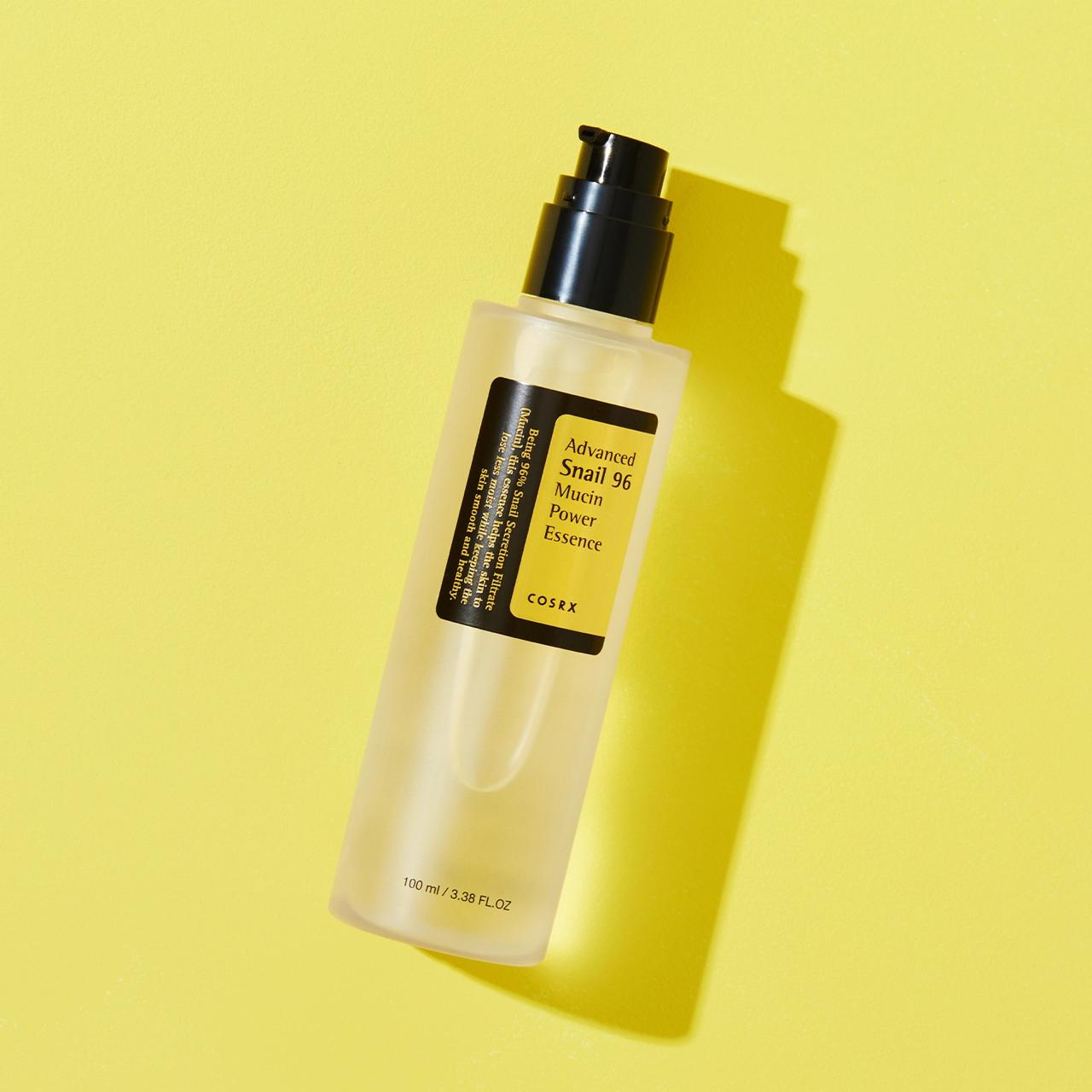 COSRX Power Essence Serum bottle on a yellow background